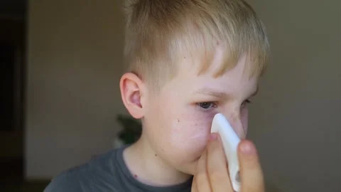 Cute 10 years old boy applying mineral sunscreen stick on his face. Caucasian ch Stock Footage 338396552