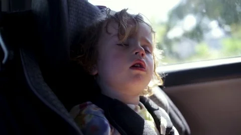 Cute 2 Year Old Curly Haired Boy Sleeps Soundly In His Car Seat, Slow Motion Video stock 79807007