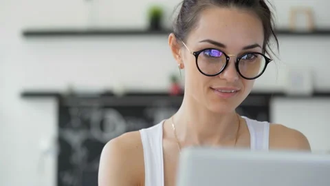Cute 20s lady working at desk in trendy hipster start up office using shared dat Stock Footage 199491306