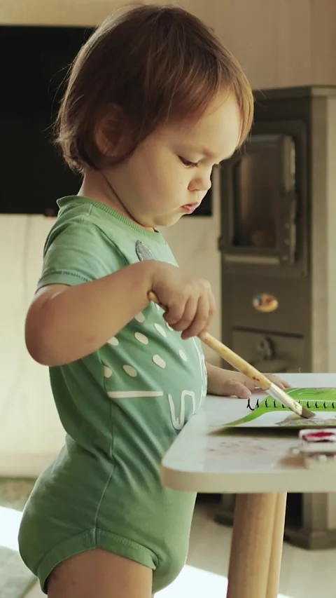 A cute 3-year-old child finds great joy in drawing and freely develops her Video stock 308720070