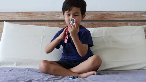 Cute 4 years boy playing with toys, sitting on bed Stock Footage 162010390