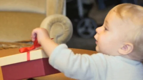 Cute 9-10 months old baby boy get's boxed present Stock Footage 82419925