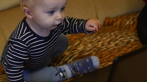 Cute 9-10 months old baby boy pressing button on pc keyboard Stock Footage 82571370
