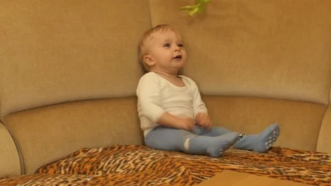Cute 9-10 months old baby boy calms down and freezes smooth zooming Stock Footage 82614616