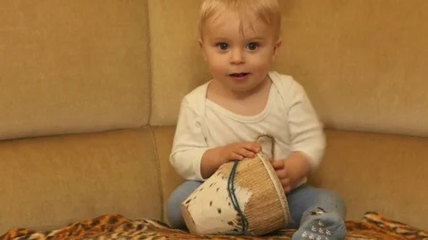 Cute 9-10 months old baby boy with music drum smooth zoom Video stock 82614618