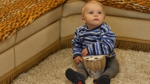 Cute 9-10 months old baby boy performance with real drum Stock Footage 82688388