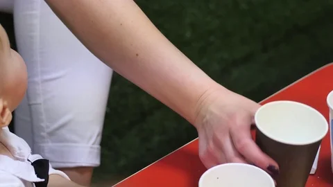 Cute 9-10 months old baby boy near the food table around other people Stock Footage 83749372