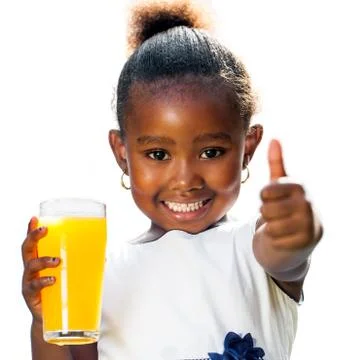 Cute african girl doing thumbs up holding orange juice Stock Photos