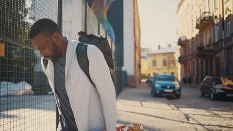 Cute African guy with beard wearing sports clothes getting smartphone out pocket Stock Footage 92054092