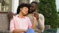 Cute afro-american couple relaxing in outdoor cafe, hugging and talking, love HD Footage