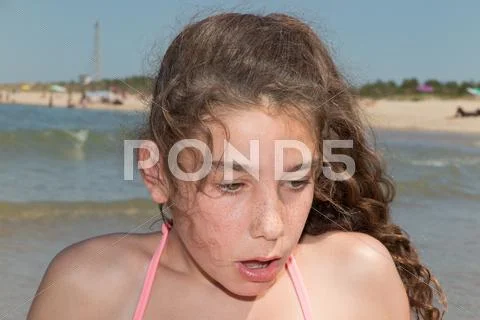 Cute and adorable teenager having fun on the beach. Stock Photos