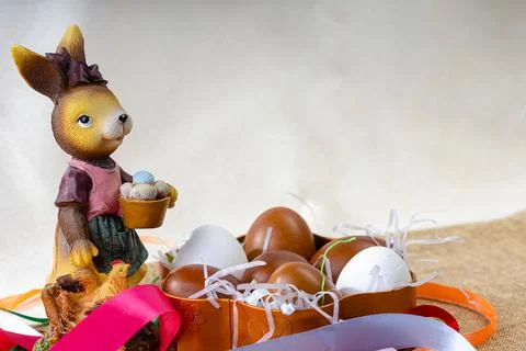 Cute and funny easter bunny and red easter eggs with colorful ribbons. Copy s Stock Photos
