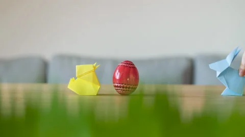 Cute and funny paper Easter bunny and chick next to a red decorated Easter egg. Stock Footage 149059602