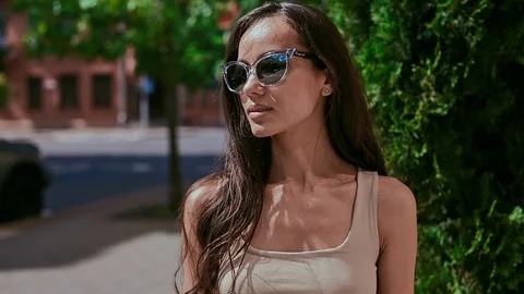 Cute and gorgeous latin women in dress posing along bright streets Stock Footage