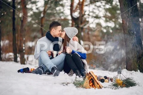 Cute and loving couple in a winter forest Stock Photos