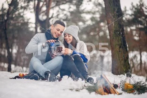 Cute and loving couple in a winter forest Stock Photos