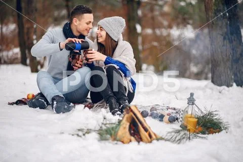 Cute and loving couple in a winter forest Stock Photos