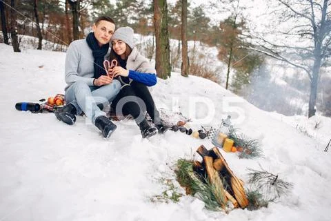 Cute and loving couple in a winter forest Stock Photos