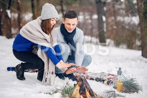 Cute and loving couple in a winter forest Stock Photos