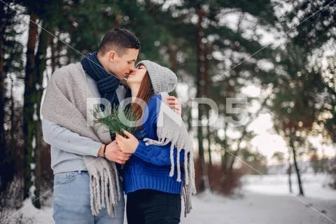 Cute and loving couple in a winter forest Stock Photos