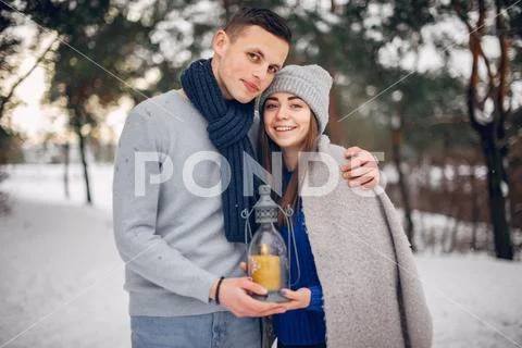 Cute and loving couple in a winter forest Stock Photos