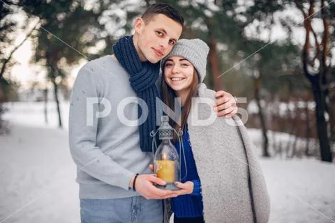 Cute and loving couple in a winter forest Stock Photos