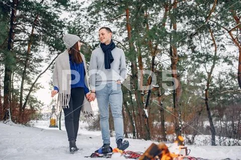 Cute and loving couple in a winter forest Stock Photos