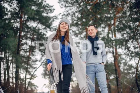 Cute and loving couple in a winter forest Stock Photos
