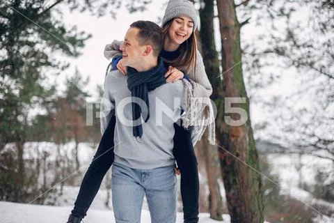 Cute and loving couple in a winter forest Stock Photos