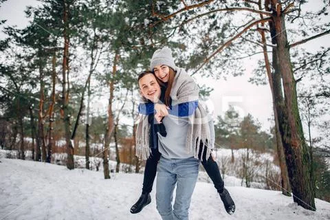Cute and loving couple in a winter forest Stock Photos