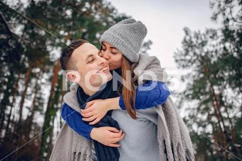 Cute and loving couple in a winter forest Stock Photos