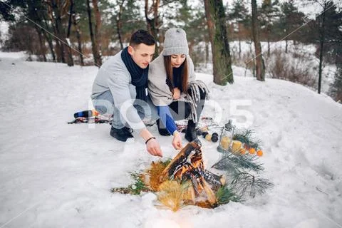 Cute and loving couple in a winter forest Stock Photos