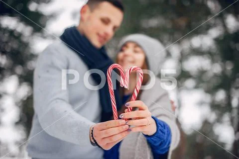 Cute and loving couple in a winter forest Stock Photos