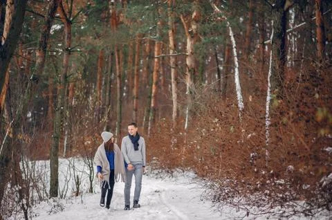 Cute and loving couple in a winter forest Stock Photos