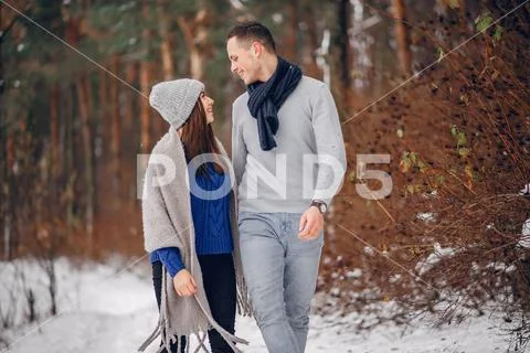 Cute and loving couple in a winter forest Stock Photos