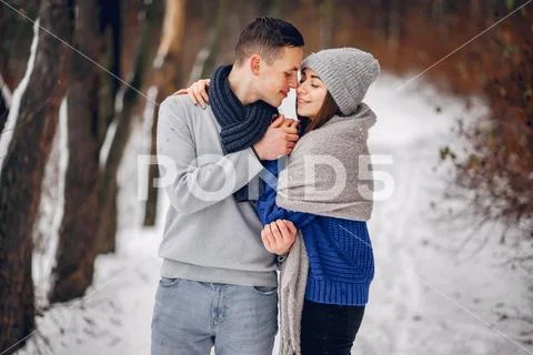 Cute and loving couple in a winter forest Stock Photos