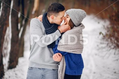 Cute and loving couple in a winter forest Stock Photos
