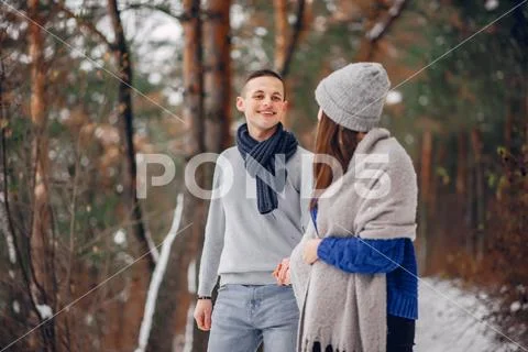 Cute and loving couple in a winter forest Stock Photos