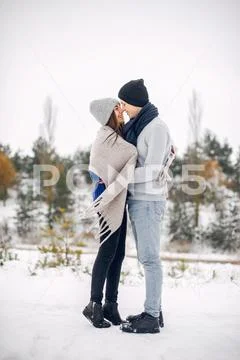Cute and loving couple in a winter forest Stock Photos