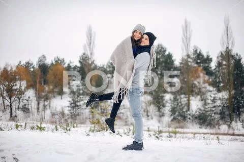 Cute and loving couple in a winter forest Stock Photos