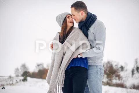 Cute and loving couple in a winter forest Stock Photos