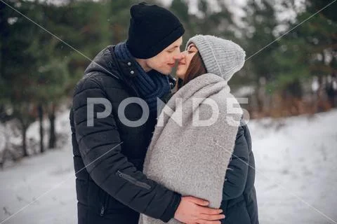 Cute and loving couple in a winter forest Stock Photos