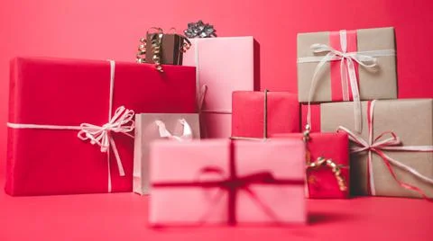 Cute and Pretty Gift Boxes on a Red Colored Background Stock Photos