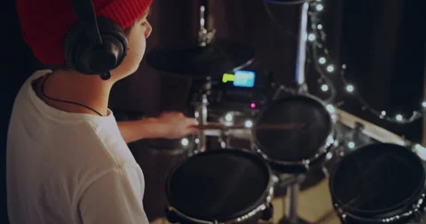 Cute and talented young boy playing drums in white tshirt performing song in 動画素材 140474654