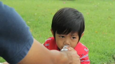 Cute Asian Boy Drinking Water At The Park Stock-Footage 10865541