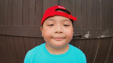 Cute asian boy with happy expression, cheerful posing summer holidayou Stock Footage 125904707
