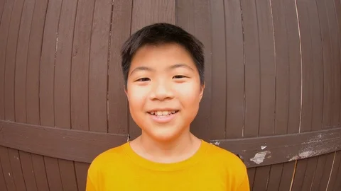 Cute asian boy with happy expression, cheerful posing summer holidayou Stock Footage 125906074