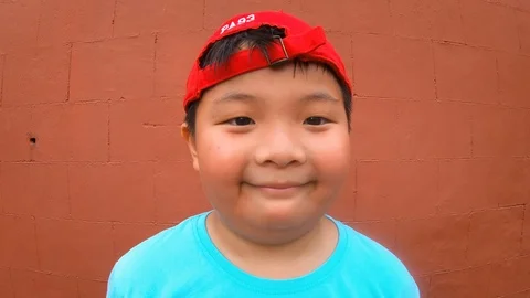 Cute asian boy with happy expression, cheerful posing summer holidayou Stock Footage 125908102