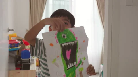 Cute Asian boy have fun showing off their cute devil drawing at home. Stock Footage 207758848