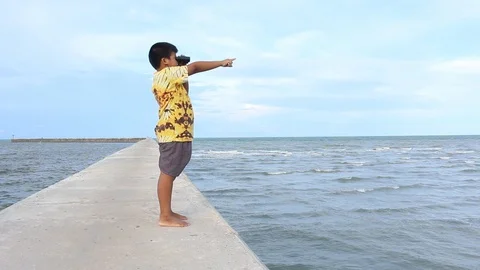 Cute asian boy looking through binoculars Stock-Footage 90968984